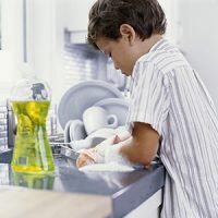 boy doing his chores - washing the dishes