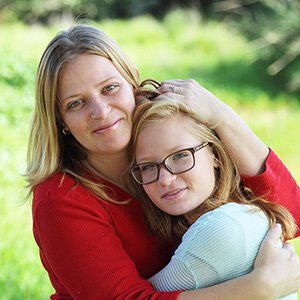 Mom hugging daughter