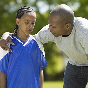 Father talking gently to daughter